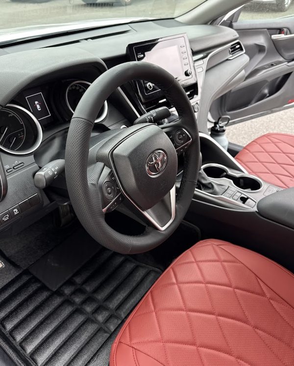 Red diamond-quilted seat covers and matching moulded floor mats fitted in a Toyota Camry