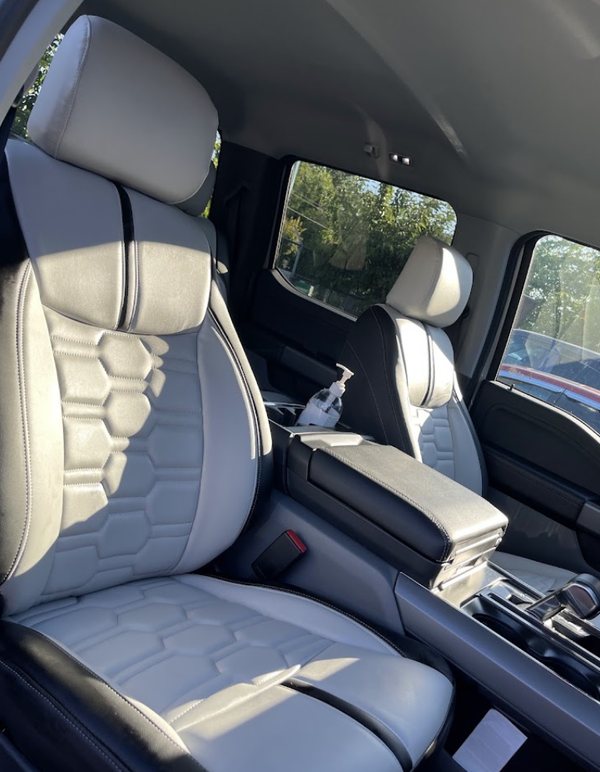 Light grey hex-quilted seat covers with black bolsters fitted in a Ford F-150
