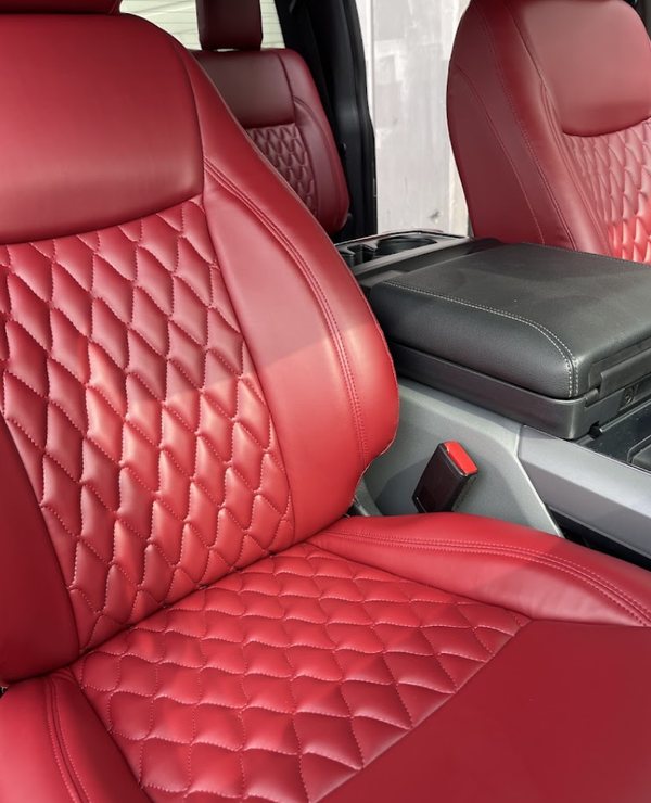 Deep red diamond-quilted seat covers and headrests in a crew cab truck