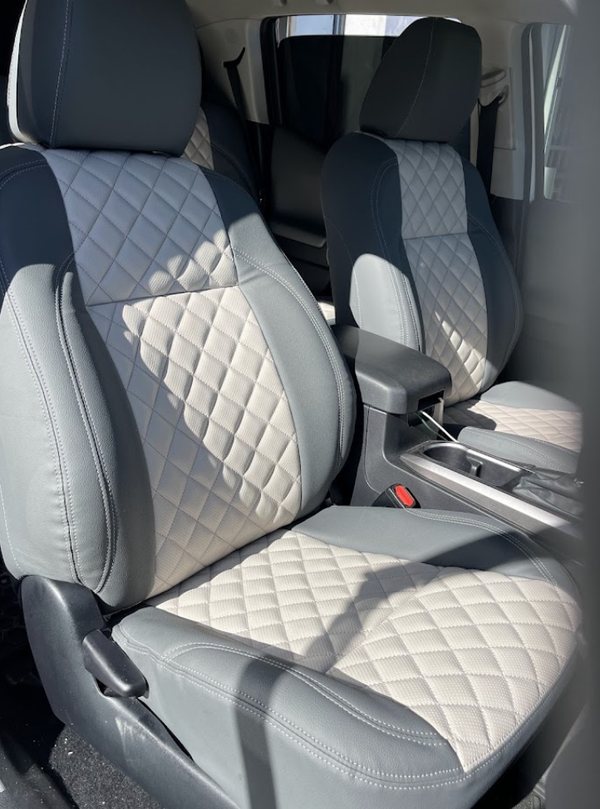 Grey and black diamond-quilted seat covers fitted in a pickup truck