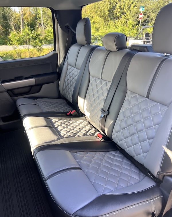 Grey and black diamond-quilted rear bench seat covers in a crew cab truck